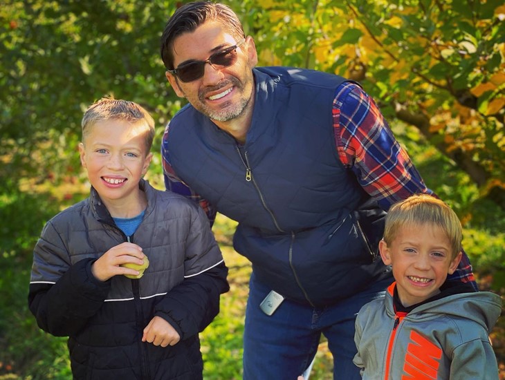 Dad with 2 sons at a trip to an apple orchard